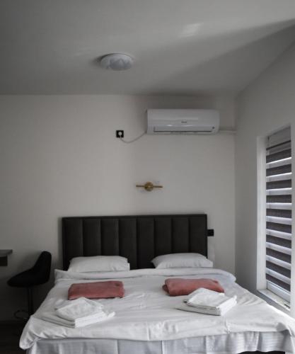 a bedroom with a large bed with two towels on it at Apartman Palermo in Višegrad