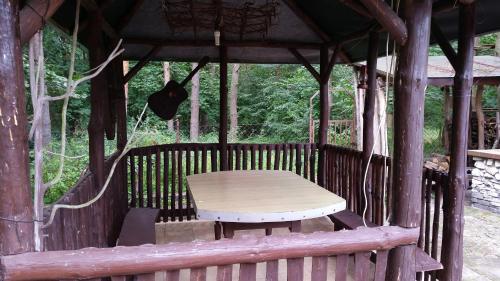 Na Skraju Lasu في Chodel: طاولة خشبية في شرفة مع طاولة نزهة