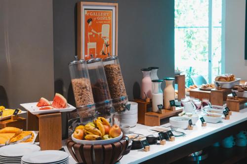 a table topped with bowls of cereal and fruit at Sites Hotel in Medellín