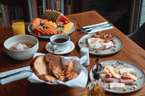 a table with plates of breakfast food and coffee at Sites Hotel in Medellín