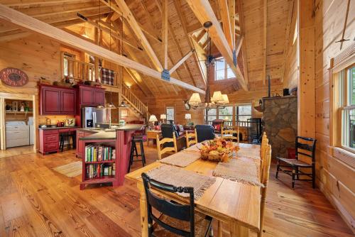 a dining room and kitchen in a log cabin at Sugars Cozy Cabin in Sugar Mountain