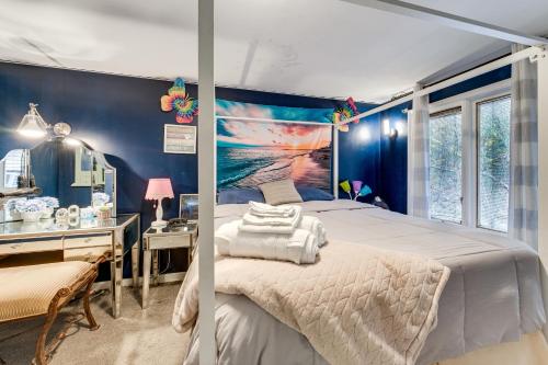 a bedroom with a bed and a desk and a mirror at Easy Cleveland Access! Quiet Suburb Stay with Yard in Oakwood