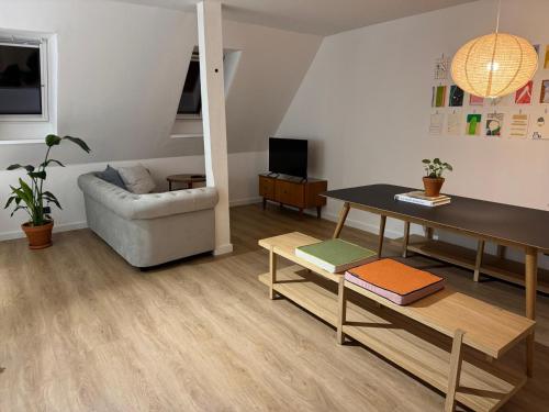 a living room with a table and a couch at Wohnen im alten Standesamt High 5 in Pasewalk