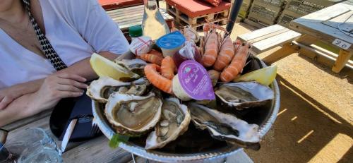 a bowl of oysters and vegetables on a table at La petite Croisière - Vue Mer in Jard-sur-Mer
