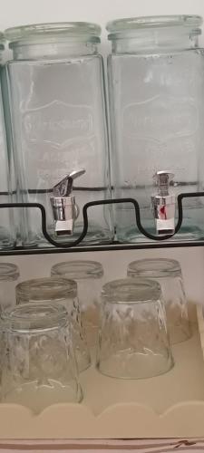 four glass jars on a shelf in a refrigerator at L'Arco sul Mare in Porto Cesareo