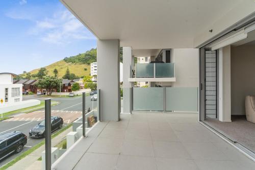 an open balcony with a view of a street at Spacious apartment in Mount Maunganui in Mount Maunganui