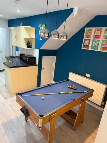 a billiard table in a room with a kitchen at Blaenavon Cosy Home in Blaenavon