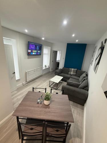 a living room with a table and a couch at Blaenavon Cosy Home in Blaenavon