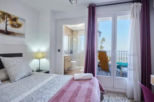 Un dormitorio con una cama y un balcón. en Casa Rural Lunares y Salinera, en Albanchez de Úbeda