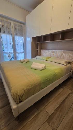 a large bed with two towels on it in a bedroom at Rocca view central flat in Arona