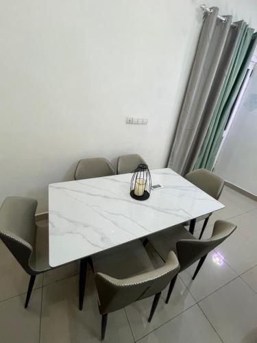 a white table and chairs in a room at Essentiel immo in Brazzaville