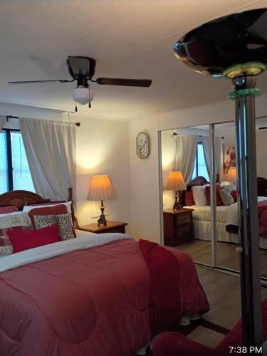 a bedroom with a red bed and a mirror at Cozy private room in Princeton