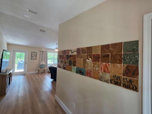 a living room with a tile accent wall at Life at the lake in Inverness