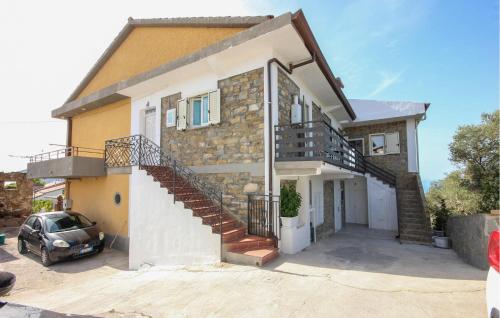 a house with a car parked in front of it at 1 Bedroom Amazing Apartment In Castellabate in Castellabate