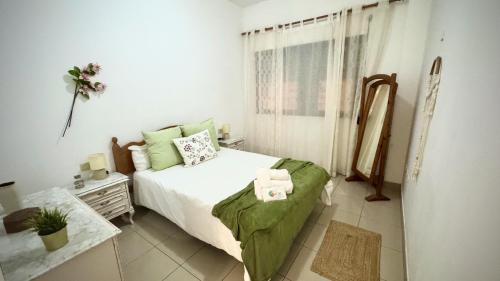 a white bedroom with a bed and a window at Menendez Bohemian Dreams by Deihu Experiences in Los Cristianos