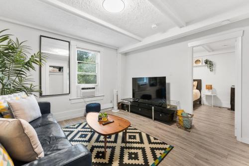 a living room with a couch and a table at Heritage Home in Heart of City with free Parking in Vancouver