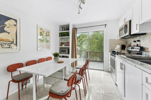 a kitchen with a white table and chairs at Heritage Home in Heart of City with free Parking in Vancouver