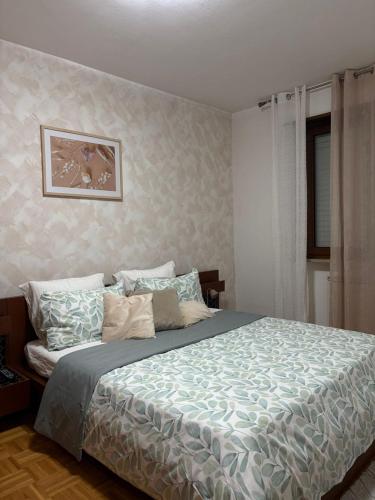 a bedroom with a bed with a blue comforter at Calvo in Ronchi dei Legionari