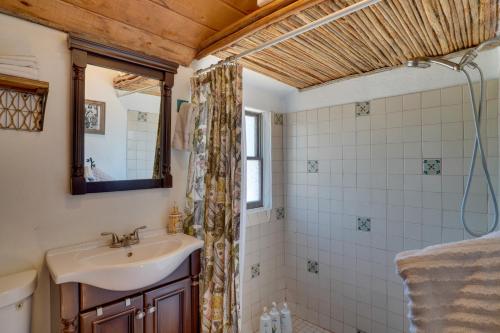 a bathroom with a sink and a mirror at Unwind Poolside, Scenic Sonoran Desert Retreat! in Tucson