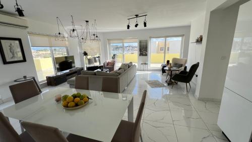 a kitchen and living room with a table with fruit on it at Renata's Three bedrooms Penthouse with Sea view in Il-Gżira