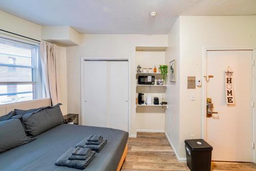 a small bedroom with a bed and a window at Cozy Studio near MassArt & Longwood, 3-Min Walk to T in Boston