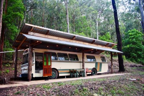 a bus with a shed on top of it at Coffee Grounds - The Coach in Coffee Camp
