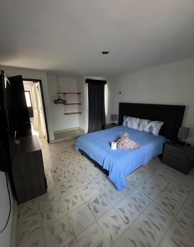 a person laying on a bed in a bedroom at Departamentos Naa'y in Valladolid