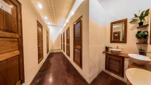 a bathroom with two sinks and two mirrors at Los Amigos Hostel in Flores