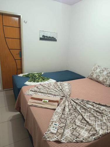 a bedroom with a bed with a blanket on it at Eds pousada in Juazeiro do Norte