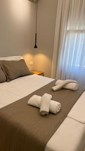two towels on a bed in a bedroom at TheCozy Home Tirana in Sauk