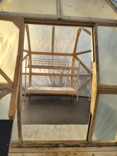 a glass house with a bench inside of it at Dome Backpackers hostel Ounasvaara in Rovaniemi