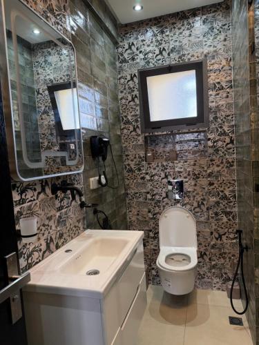 a bathroom with a toilet and a sink and a mirror at Vue Mer Exeptionnelle à Essaouira in Essaouira
