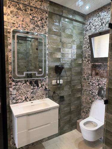 a bathroom with a sink and a toilet at Vue Mer Exeptionnelle à Essaouira in Essaouira