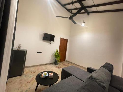 a living room with a couch and a table at Harbor Moon in Hiriketiya