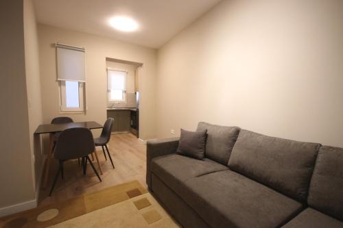 ein Wohnzimmer mit Sofa und Tisch in der Unterkunft Jera Apartment 1 in Tirana