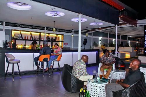 a group of people sitting at a bar at Dreamz Hotel and Suites in Ogbomoso