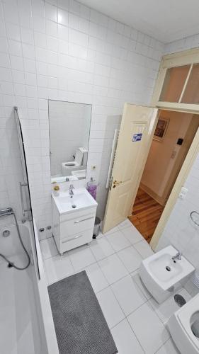a white bathroom with a sink and a toilet at Costa do Castelo Lisbon Accomodation - By Grupo Lisboa Alojamentos in Lisbon