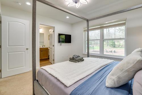 a bedroom with a large bed and a window at Hot Tub and Lake Access Spacious Tobyhanna Home in Tobyhanna
