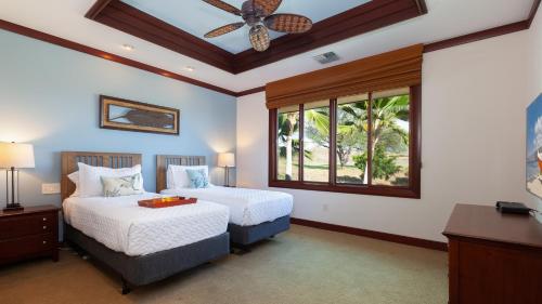 a bedroom with two beds and a ceiling fan at ❤PiH❤ Endless Ocean Views Villa Gorgeous Mauna Kea Ocean and Mountain View in Hapuna Beach