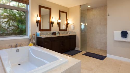 a large bathroom with a large tub and a shower at HOUSE OF JOY Light and Airy 4BR KaMilo Home with Heated Pool and Spa in Waikoloa