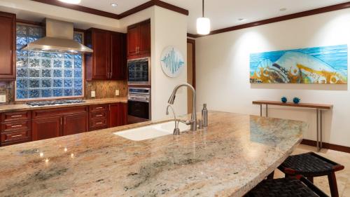 a kitchen with a large marble counter top at ❤PiH❤ A Sea-nic Escape Stunning Ocean View Mauna Kea Resort eBikes in Hapuna Beach