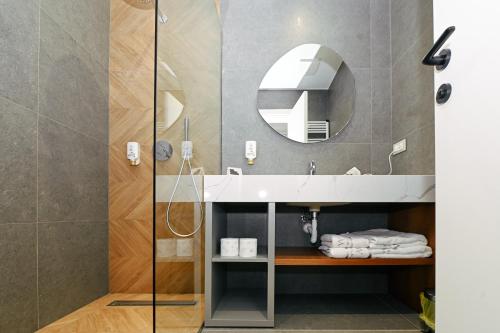 a bathroom with a sink and a mirror at Wilson On The Bllok in Tirana