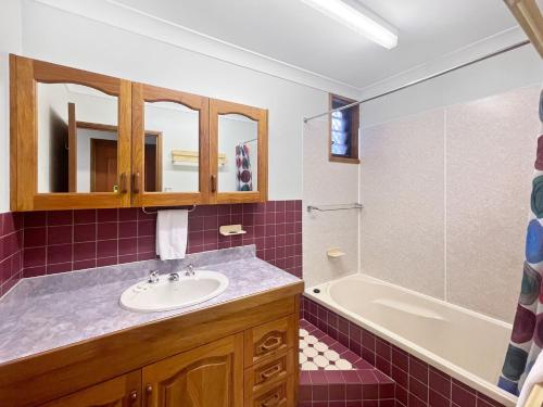 a bathroom with a sink and a tub at Arcadia Gardens in Arcadia