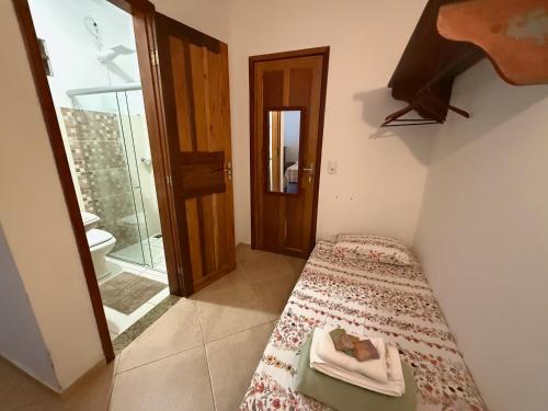 Una pequeña habitación con una cama y un baño. en Vila Santíssimo Hospedagem e Café, en PatrimÃ´nio da Penha