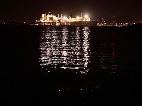 a large ship on the water at night at Across from Jetty Park and Best Ship Watching in Surfside