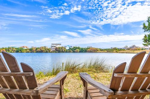 two chairs sitting on the shore of a lake at 8198 - Still Waters in Waves