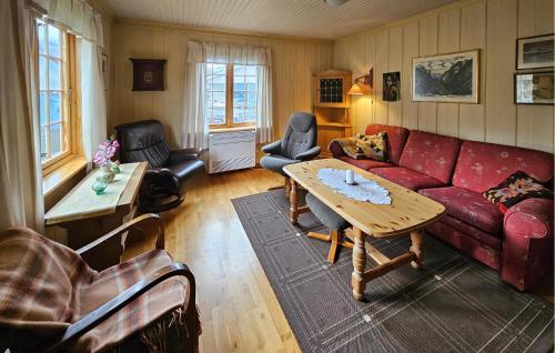 a living room with a red couch and a table at Beautiful Home In Dalen With Harbor View in Dalen