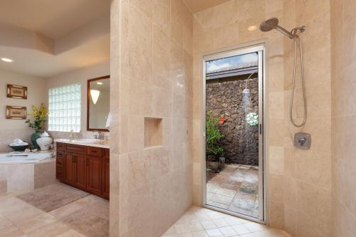 a bathroom with a shower and a sink at PiH: Aloha Palms~ Fully Detached Home Beach Gear Bikes in Waikoloa