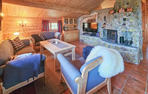 a living room with couches and a stone fireplace at 4 Bedroom Gorgeous Home In Rjukan in Gaustablikk