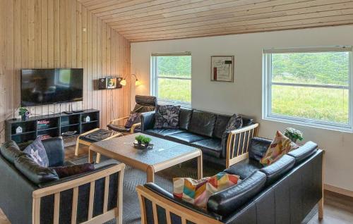a living room with a couch and a table at Amazing Home In Væggerløse With Sauna in Marielyst